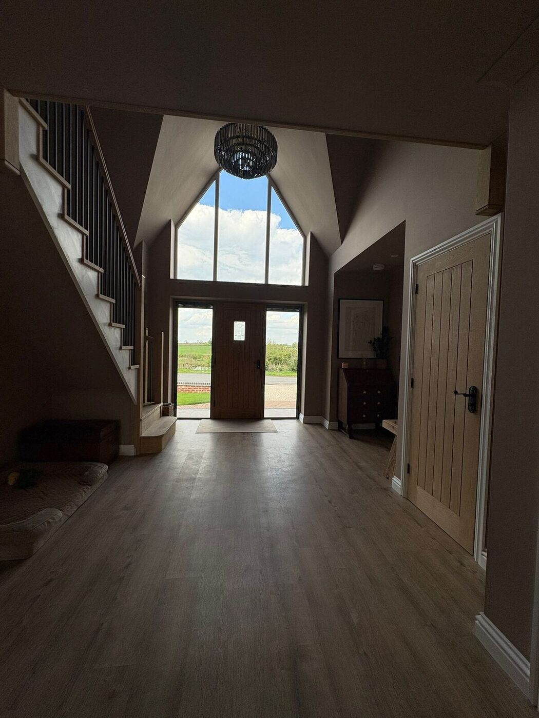 Grand hallway entrance with feature apex glazing and bespoke oak staircase