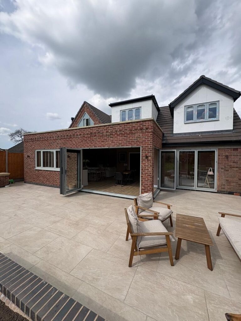 The Wolvey property rear after the remodel: extension, bifolds and patio